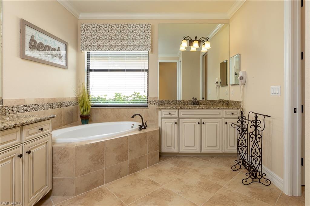2918 Aviamar Circle Naples, FL 34114 - Photo 12 of 25 a spacious bathroom with a double vanity sink mirror and bathtub