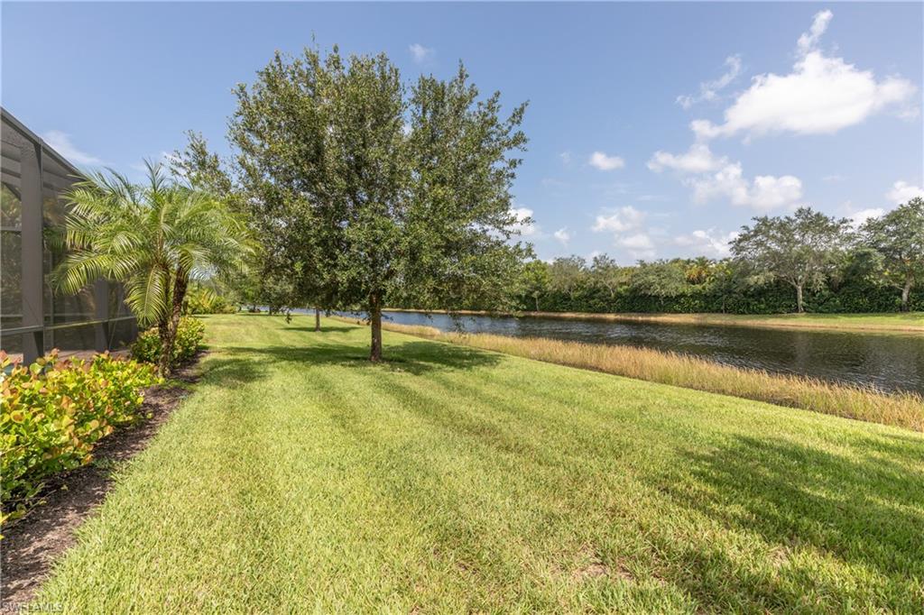 2918 Aviamar Circle Naples, FL 34114 - Photo 24 of 25 a view of a lake with a yard