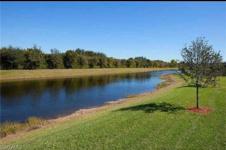 2918 Aviamar Circle Naples, FL 34114 - Photo 25 of 25 a view of a lake with houses in the back