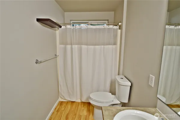 a bathroom with a toilet and shower