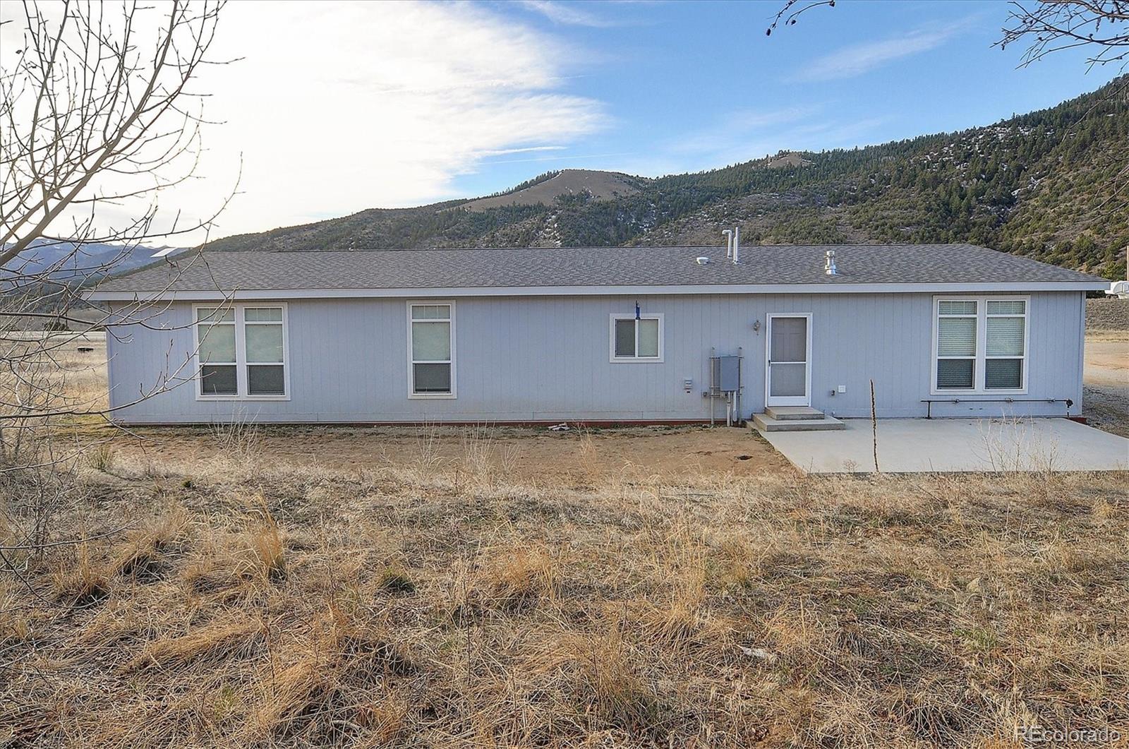 16554 Rocky Mountain Road Salida, CO 81201 - Photo 32 of 33 front view of house with a yard