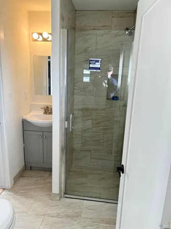 a bathroom with a shower and a sink