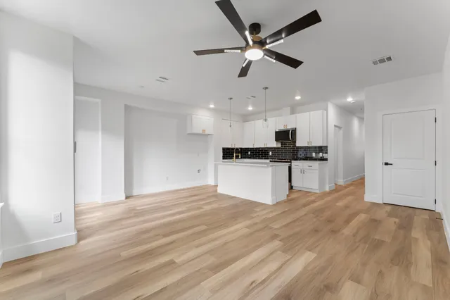 a view of kitchen with refrigerator and microwave