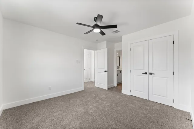 a view of empty room with ceiling fan