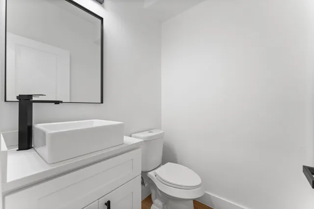 a white toilet sitting next to a white tub