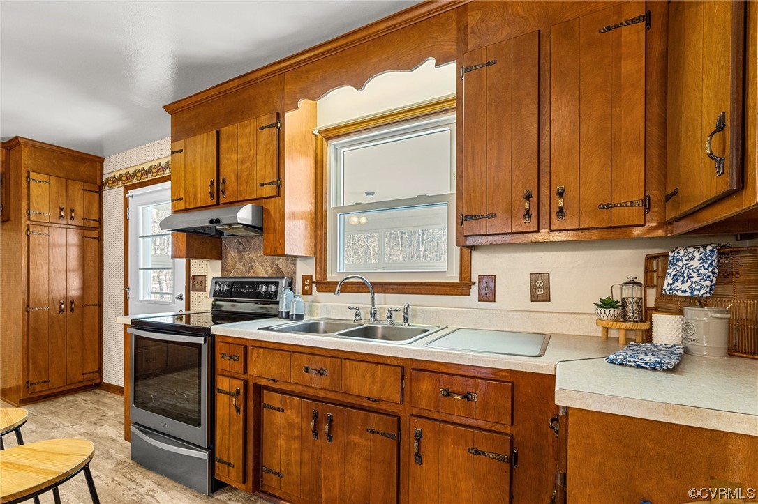 17543 Le Master Road Petersburg, VA 23803 - Photo 12 of 49 a kitchen with stainless steel appliances granite countertop a sink a stove and a refrigerator