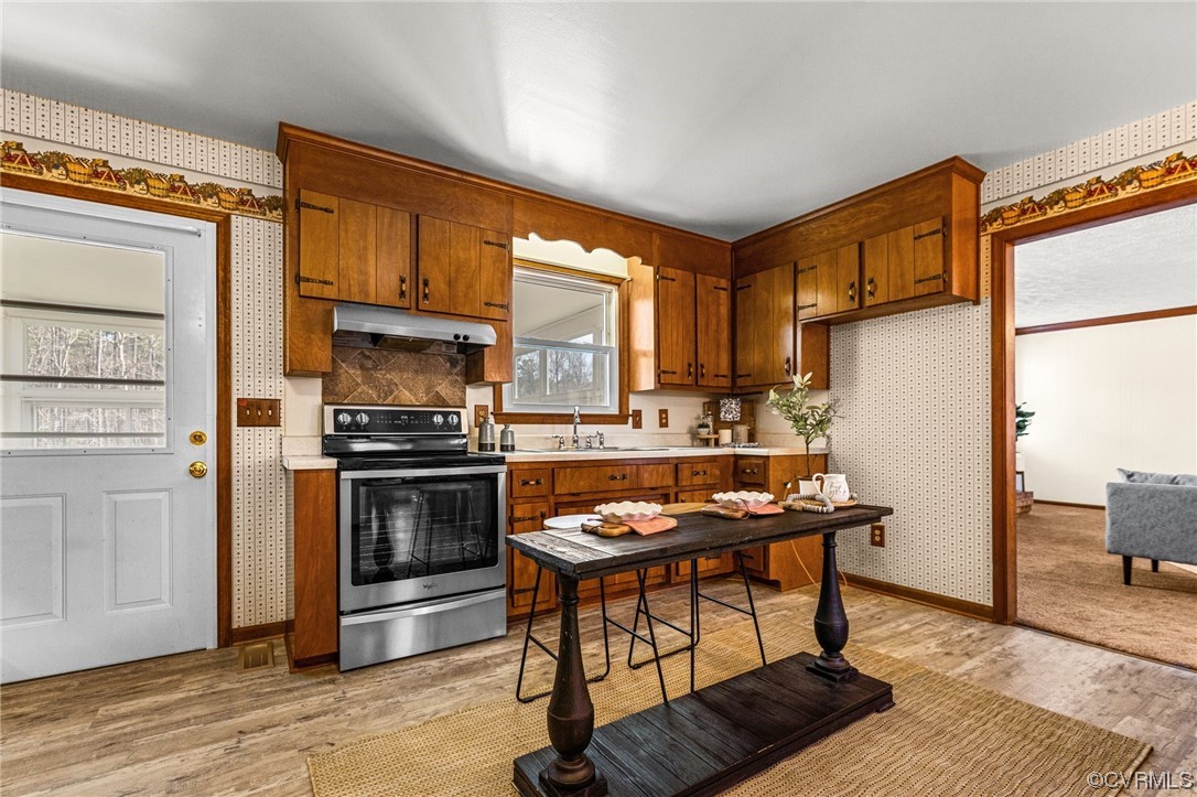 17543 Le Master Road Petersburg, VA 23803 - Photo 13 of 49 a kitchen with stainless steel appliances granite countertop a stove refrigerator and a sink with granite countertops