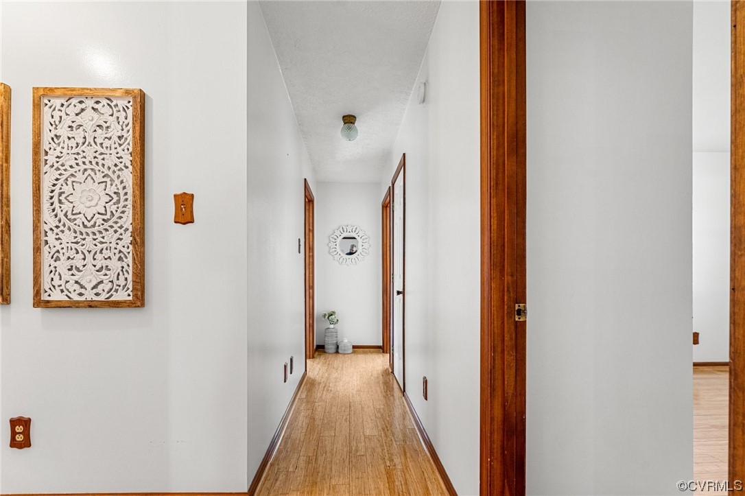 17543 Le Master Road Petersburg, VA 23803 - Photo 24 of 49 a view of a hallway with paintings on the wall