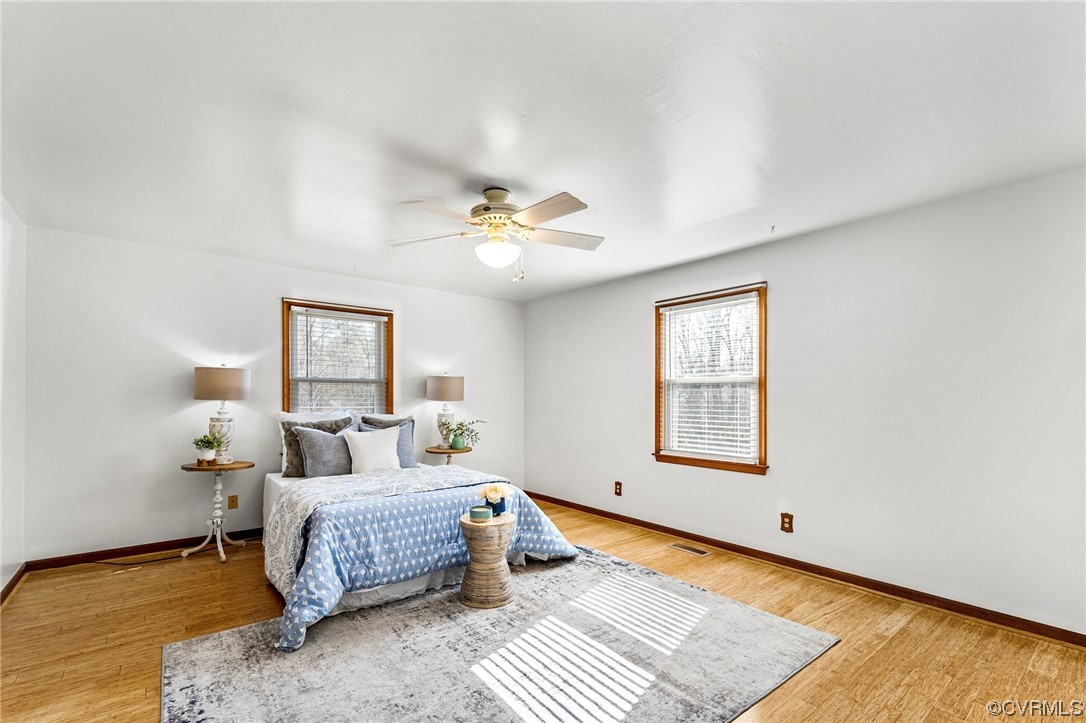 17543 Le Master Road Petersburg, VA 23803 - Photo 30 of 49 a bedroom with a bed lamp and a chandelier