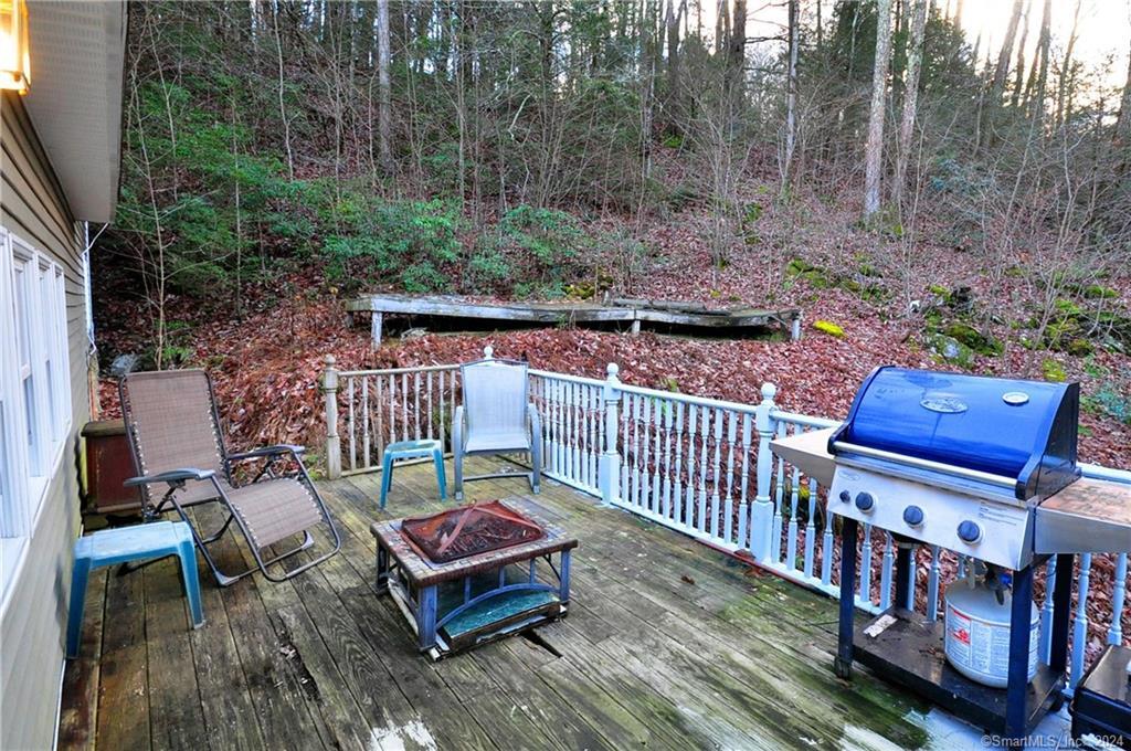 45 Barkhamsted Road Granby, CT 06090 - Photo 31 of 35 a balcony with wooden floor outdoor seating and yard in the back