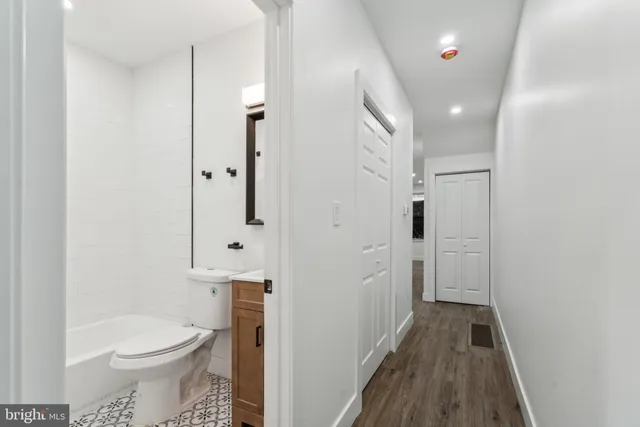a view of a room with wooden floor and white walls
