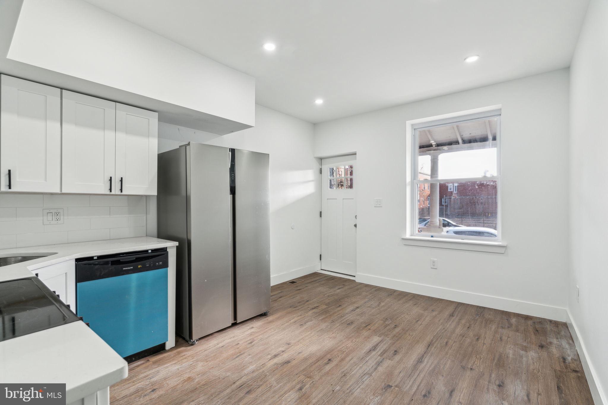 6013 Walnut Street Philadelphia, PA 19139 - Photo 4 of 21 a view of a kitchen with a fridge and wooden floor