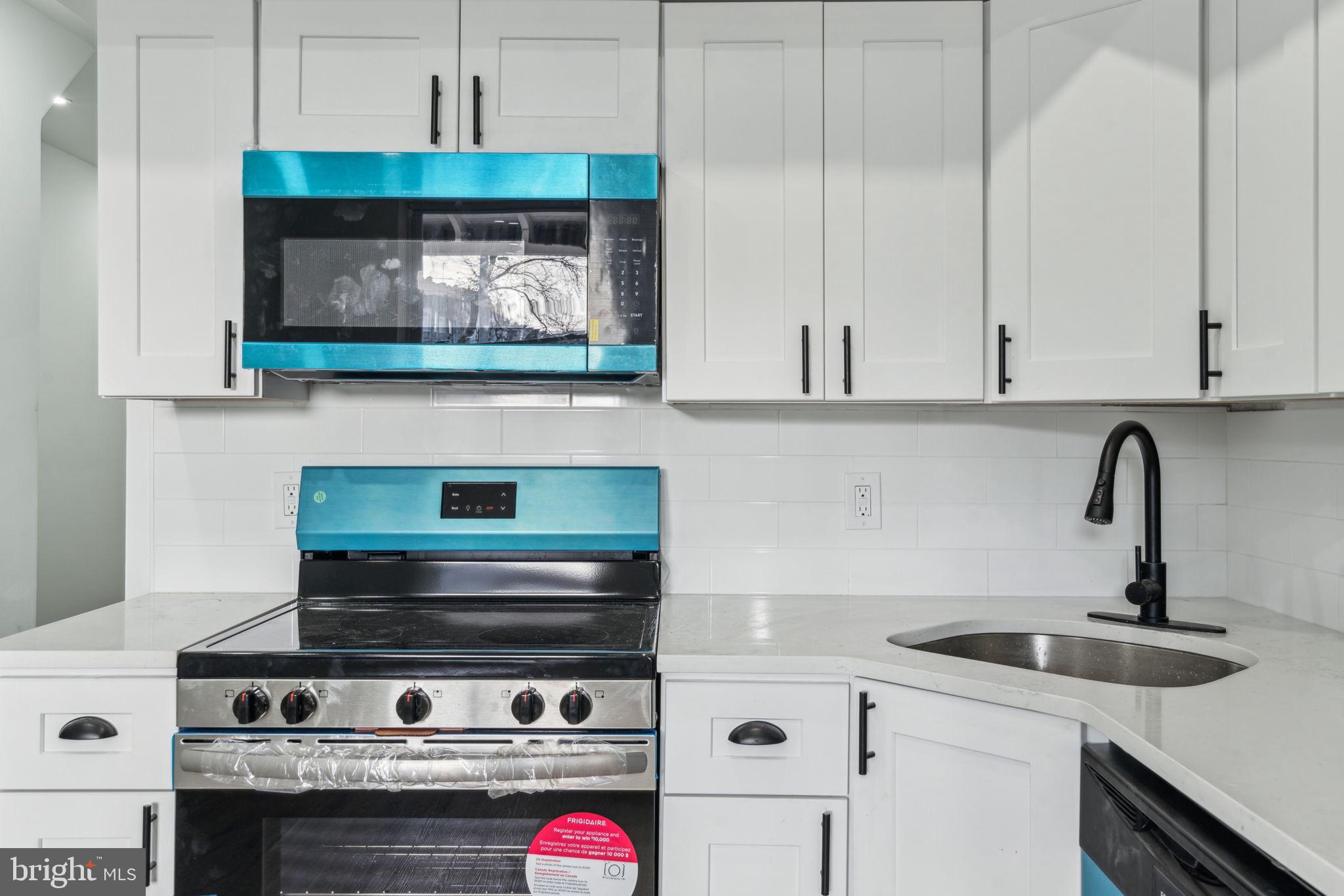 6013 Walnut Street Philadelphia, PA 19139 - Photo 6 of 21 a kitchen with a stove and cabinets