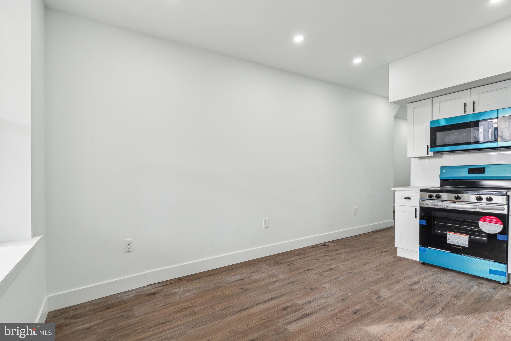 6013 Walnut Street Philadelphia, PA 19139 - Photo 8 of 21 a view of kitchen with wooden floor and stove