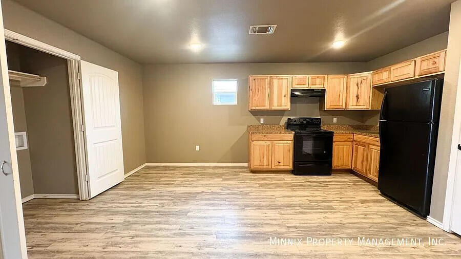517 44th Street Lubbock, TX 79404 - Photo 6 of 10 a kitchen with stainless steel appliances granite countertop a refrigerator stove and sink