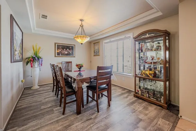a view of a dining room with furniture and chandelier