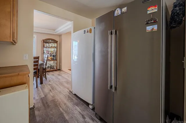 a view of a hallway with wooden floor and furniture