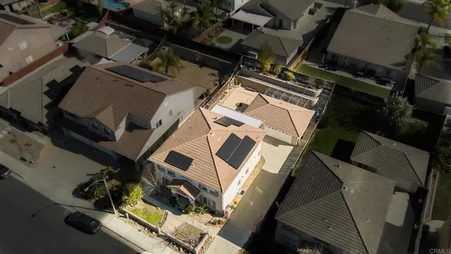 an aerial view of a backyard with table and chairs