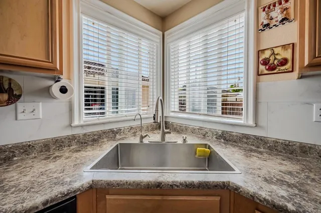 a kitchen with granite countertop a sink and a window