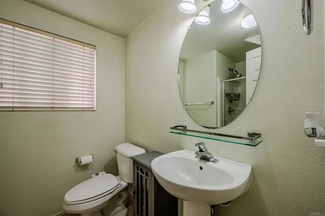 a bathroom with a sink a mirror and a toilet