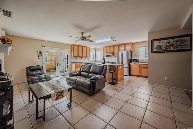 a living room with furniture and a open kitchen view