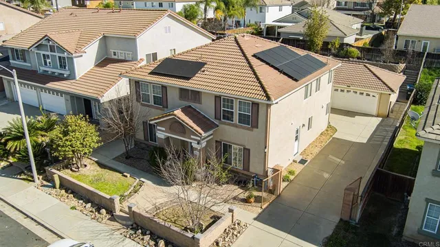 a aerial view of a house with chairs