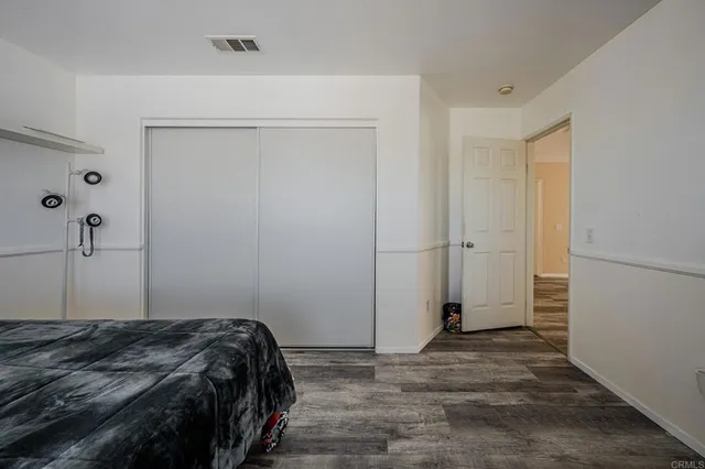 a bedroom with a bed and hallway