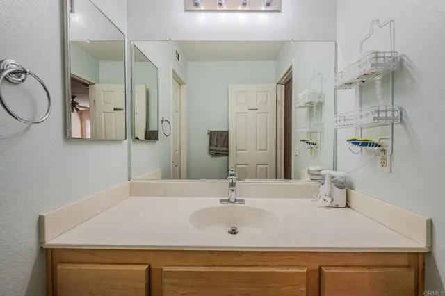 a bathroom with a sink a mirror and shower