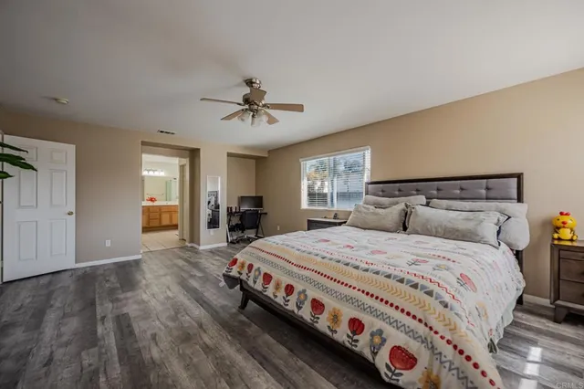 a bedroom with a large bed and a chandelier