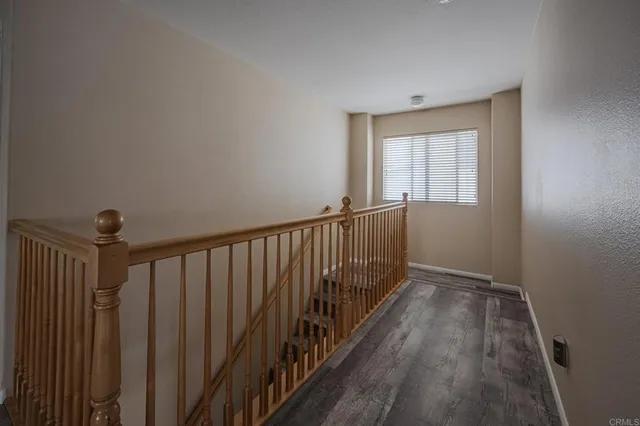 a view of hallway with wooden floor