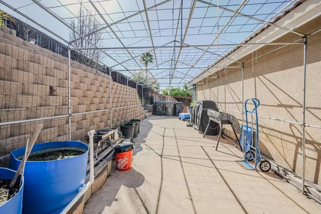 a view of a patio with table and chairs