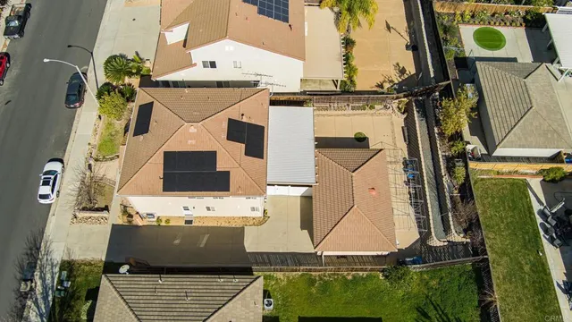 an aerial view of a house with a yard