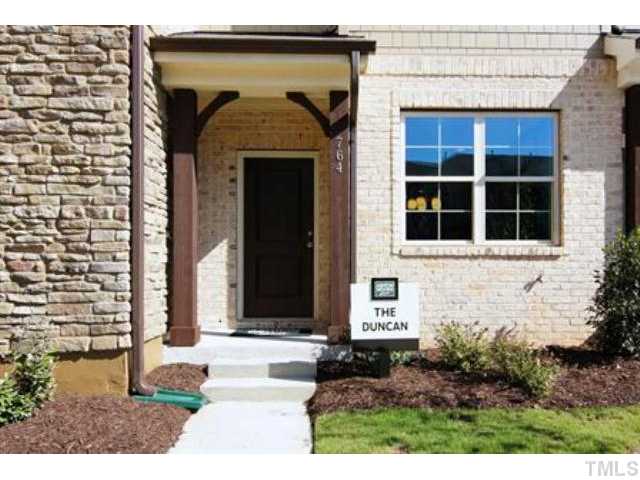 717 Wickham Ridge Road Apex, NC 27539 - Photo 1 of 25 a front view of a house with a yard