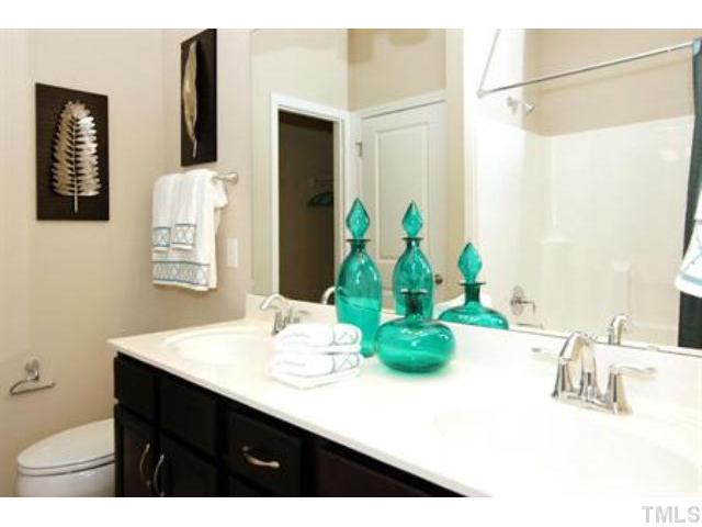 717 Wickham Ridge Road Apex, NC 27539 - Photo 16 of 25 a bathroom with a sink and a mirror