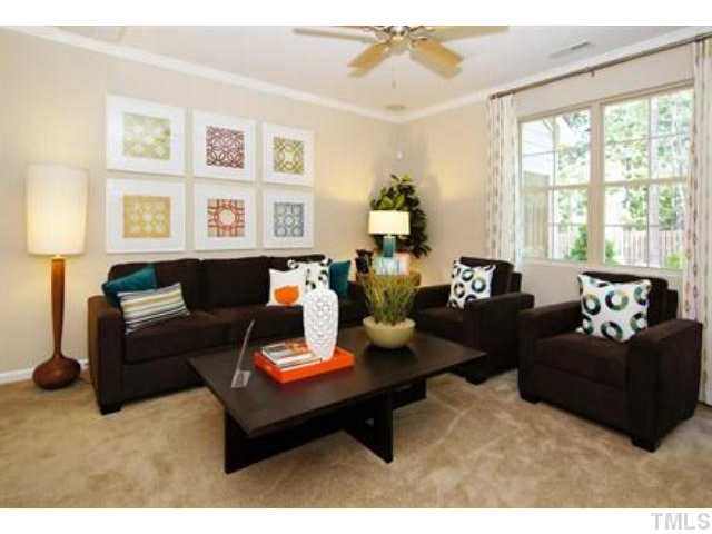 717 Wickham Ridge Road Apex, NC 27539 - Photo 9 of 25 a living room with furniture and a large window