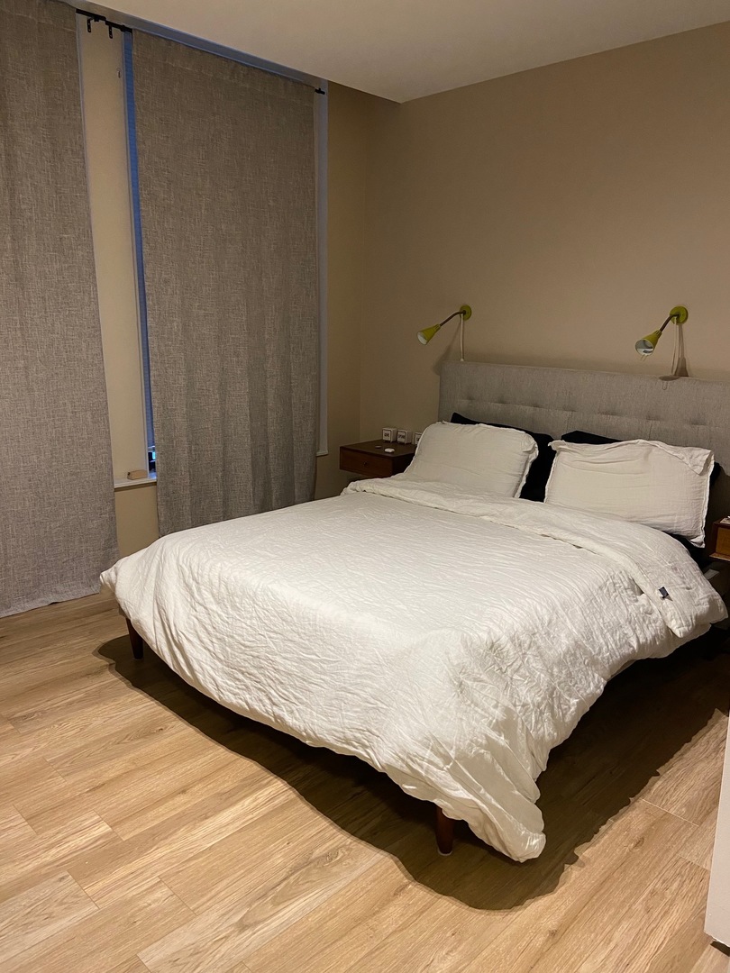431 South Dearborn Street, Unit 209 Chicago, IL 60605 - Photo 7 of 11 a large bed sitting in a bedroom next to a window