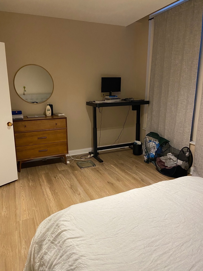 431 South Dearborn Street, Unit 209 Chicago, IL 60605 - Photo 8 of 11 a bedroom with a bed and cabinets