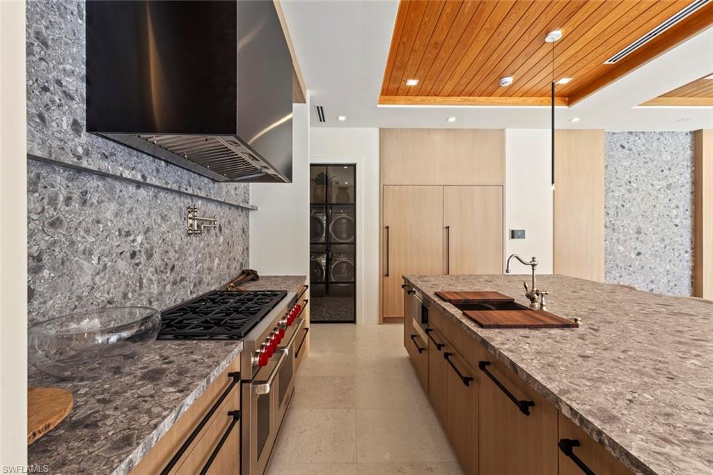 508 16th Avenue South Naples, FL 34102 - Photo 14 of 50 Kitchen with a raised ceiling, wooden ceiling, dark stone countertops, extractor fan, and range with two ovens