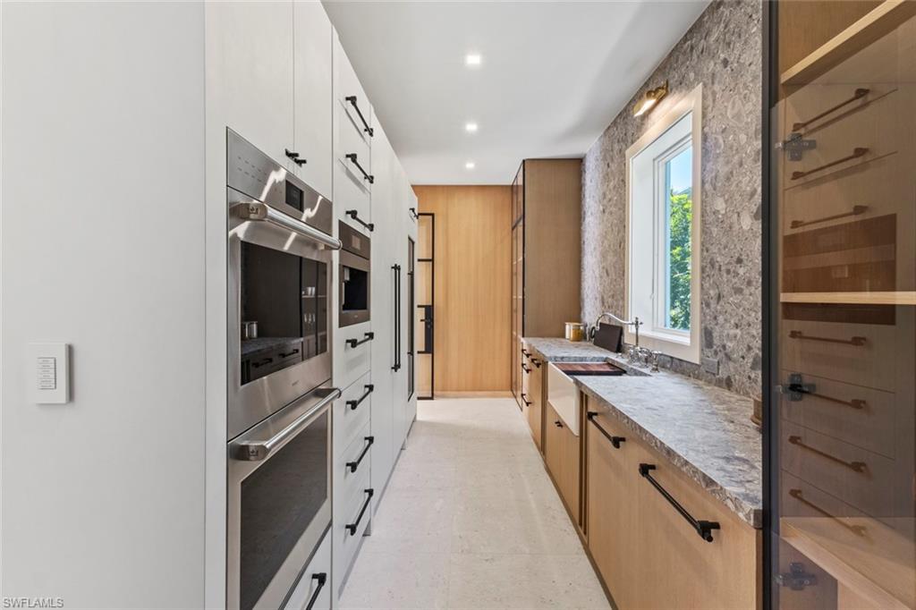 508 16th Avenue South Naples, FL 34102 - Photo 16 of 50 Kitchen with stainless steel double oven, white cabinetry, modern cabinets, and recessed lighting