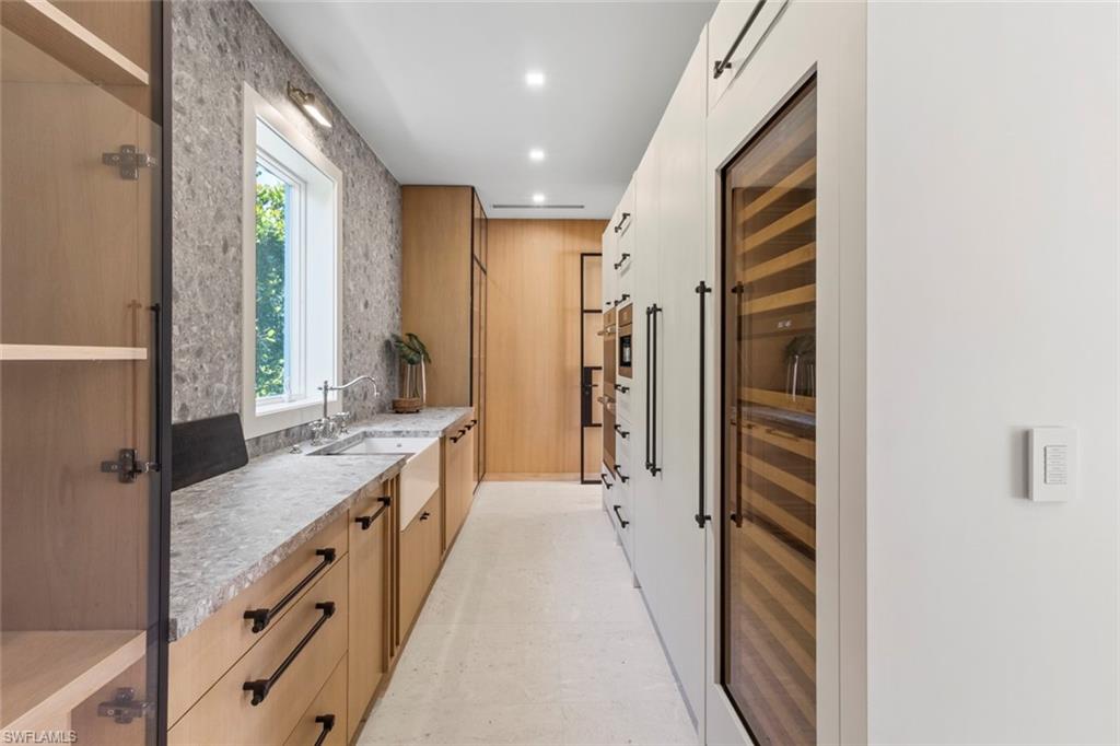508 16th Avenue South Naples, FL 34102 - Photo 17 of 50 Bathroom with vanity, beverage cooler, and recessed lighting