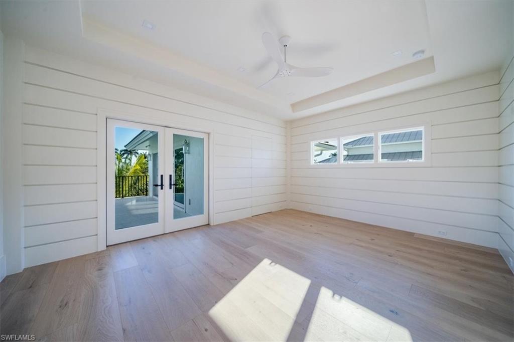 508 16th Avenue South Naples, FL 34102 - Photo 22 of 43 Bedroom #3 with shiplap and balcony access.