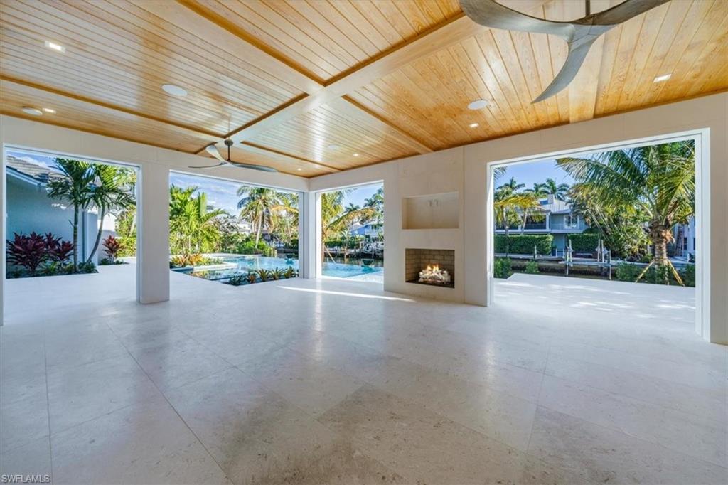 508 16th Avenue South Naples, FL 34102 - Photo 36 of 43 Outdoor living space and fireplace.