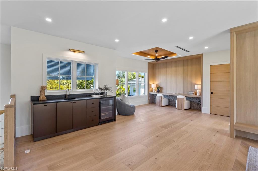 508 16th Avenue South Naples, FL 34102 - Photo 38 of 50 Kitchen with recessed lighting, wine cooler, dark countertops, light wood-style flooring, and dark brown cabinetry