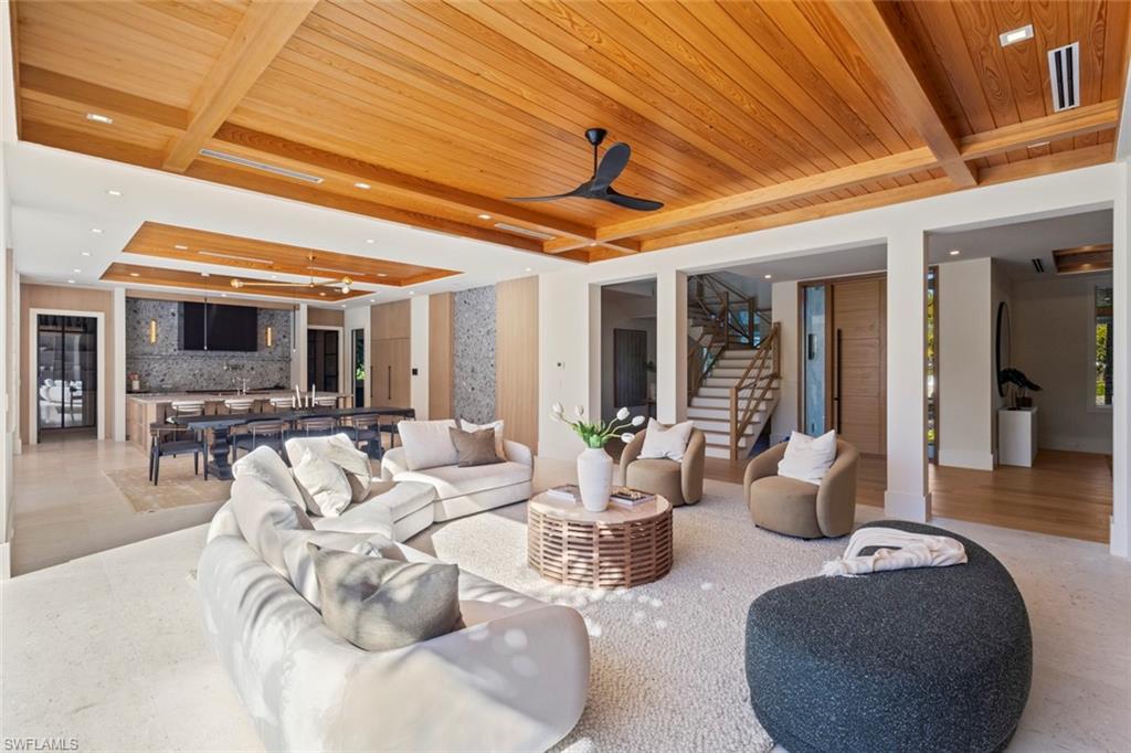 508 16th Avenue South Naples, FL 34102 - Photo 4 of 50 Living area with a raised ceiling, stairway, a wood ceiling with exposed beams, recessed lighting, and a ceiling fan