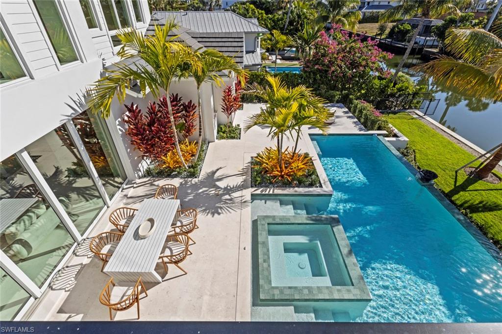 508 16th Avenue South Naples, FL 34102 - Photo 44 of 50 View of swimming pool featuring a pool with connected hot tub and a patio