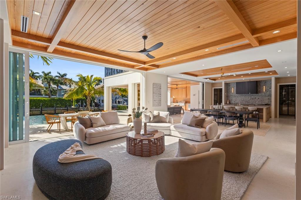 508 16th Avenue South Naples, FL 34102 - Photo 5 of 50 View of patio / terrace featuring outdoor dining space, a ceiling fan, and an outdoor living space
