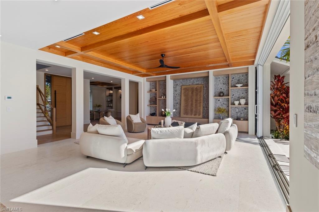 508 16th Avenue South Naples, FL 34102 - Photo 7 of 50 Living area with a wood ceiling with exposed beams, stairway, and ceiling fan