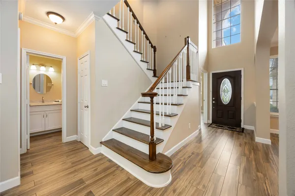a view of entryway and hall with wooden floor