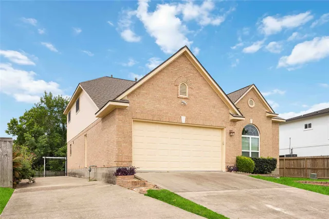 a large kitchen with stainless steel appliances and white cabinets