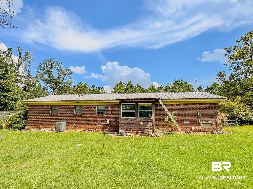 1456 Allen Walker Road Grove Hill, AL 36451 - Photo 4 of 28 Back of house featuring a yard and brick siding